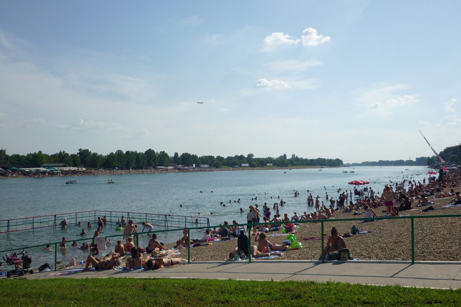 Swimmers and sunbathers on the lake beach at Ada Ciganlija in Belgrade in summer