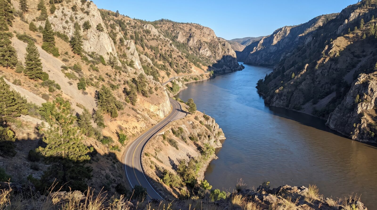 A narrow road cut into the cliffside, following the curve of the Danube through the gorge