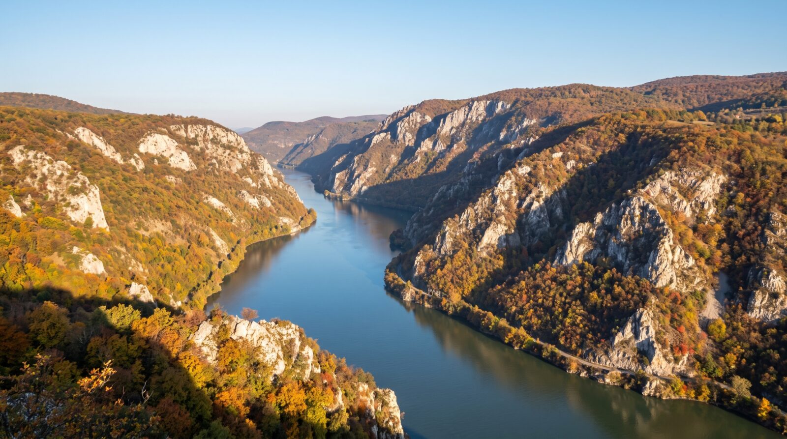 The Danube narrowing between steep, wooded hillsides as it enters the Djerdap gorge