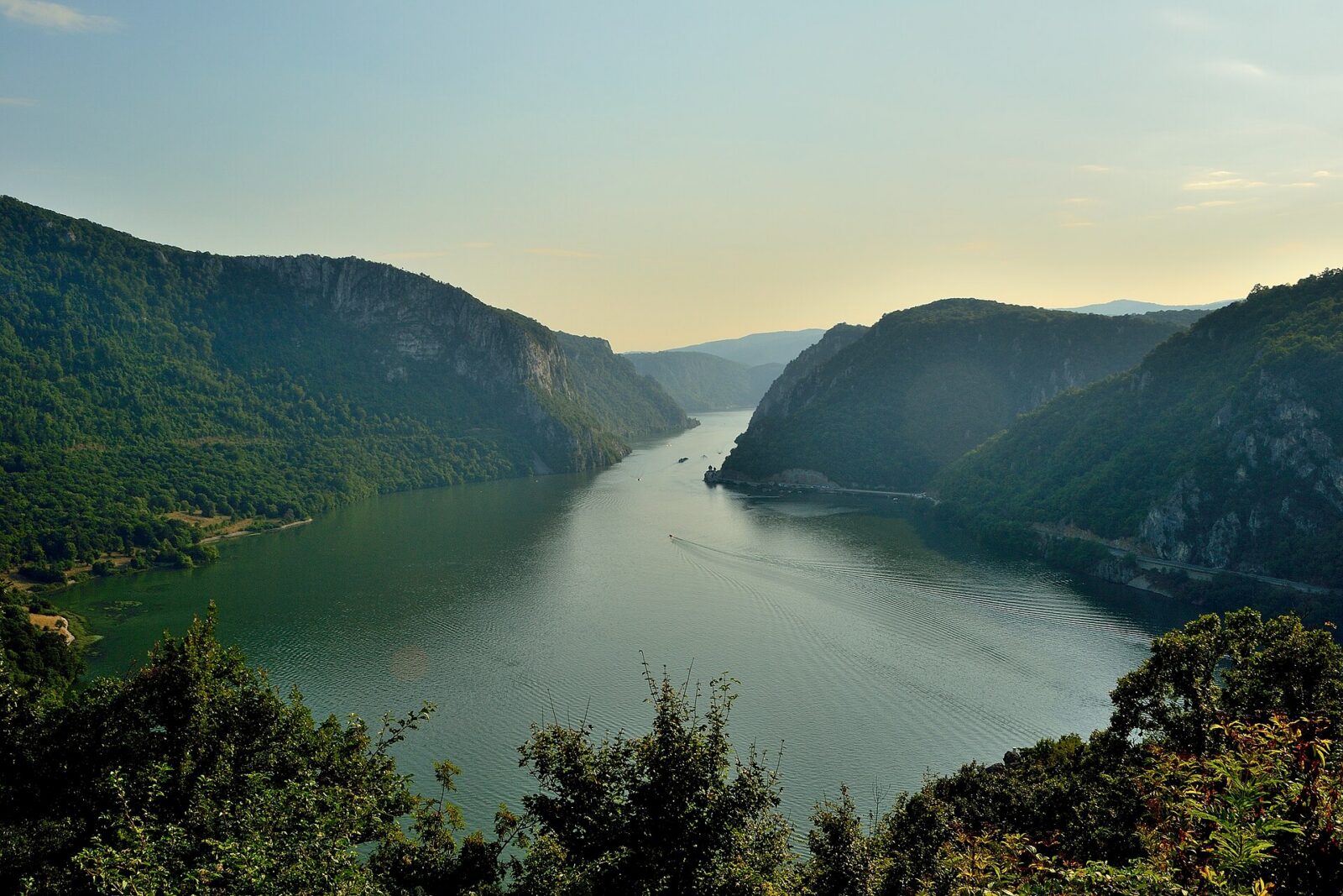 The Đerdap gorge, where steep forested cliffs drop straight into the Danube