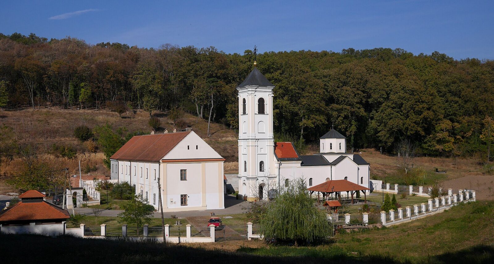 A monastery building set among trees on the wooded slopes of Fruska Gora