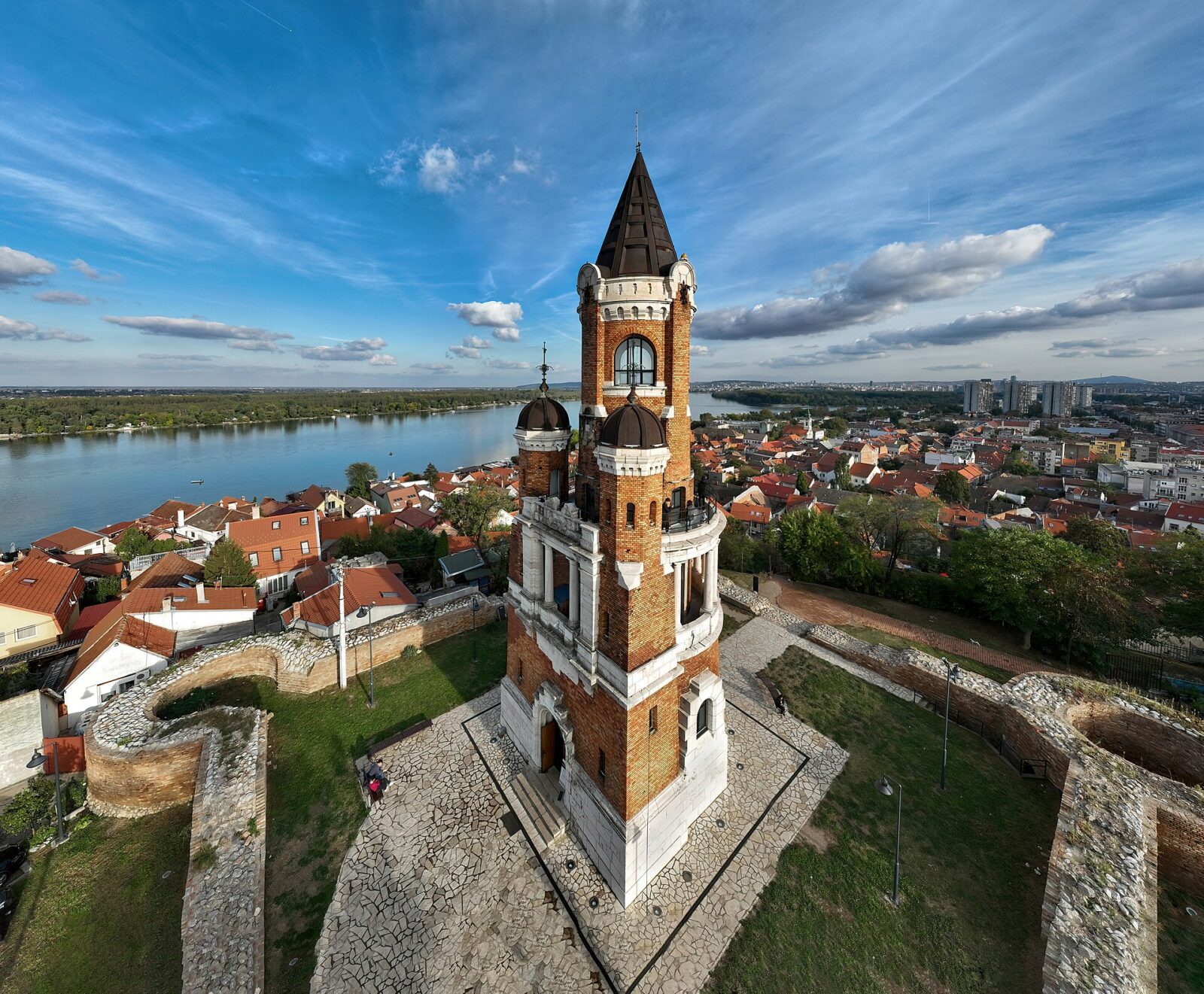 An aerial view of the Millennium Tower on Gardos hill, with the Danube and Zemun's rooftops beyond