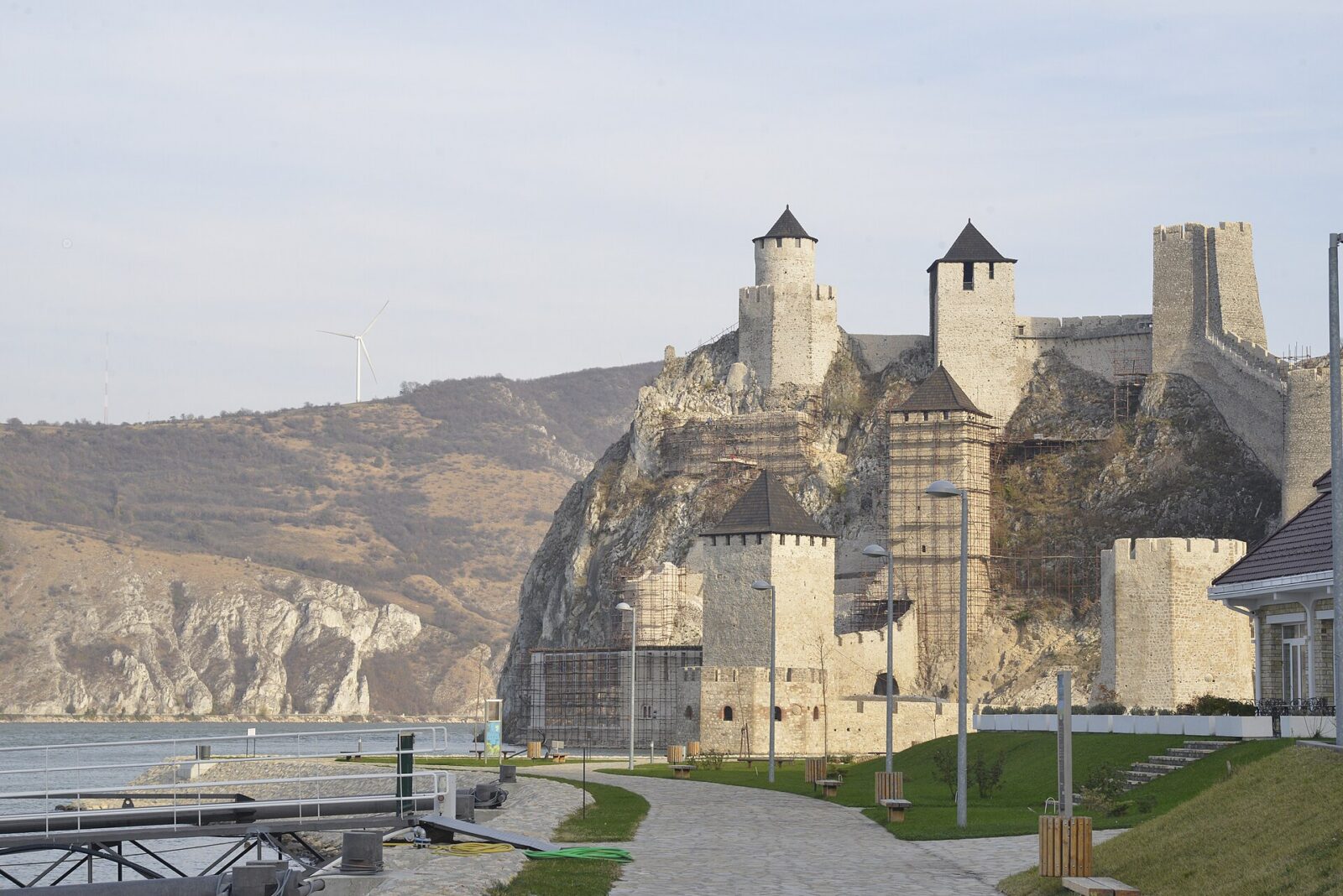 The wide Danube river flowing past Golubac Fortress, seen from below the walls
