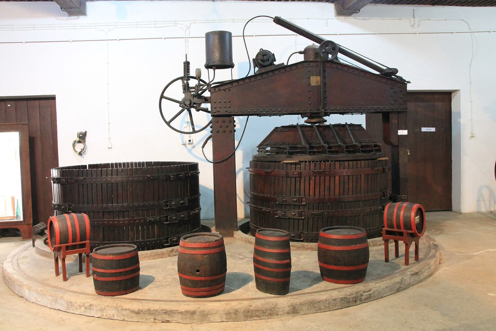 The wine press and barrels on display inside the King's Winery at Oplenac