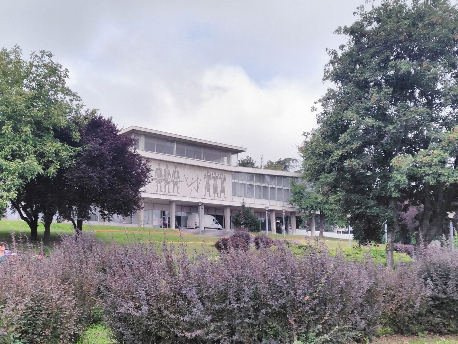 The Museum of Yugoslavia seen across its grounds, framed by trees