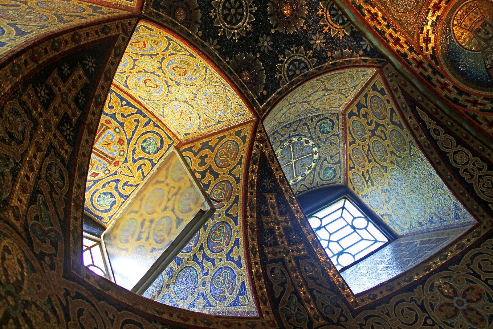 Mosaic-covered ceiling and windows inside the crypt of St George's Church at Oplenac