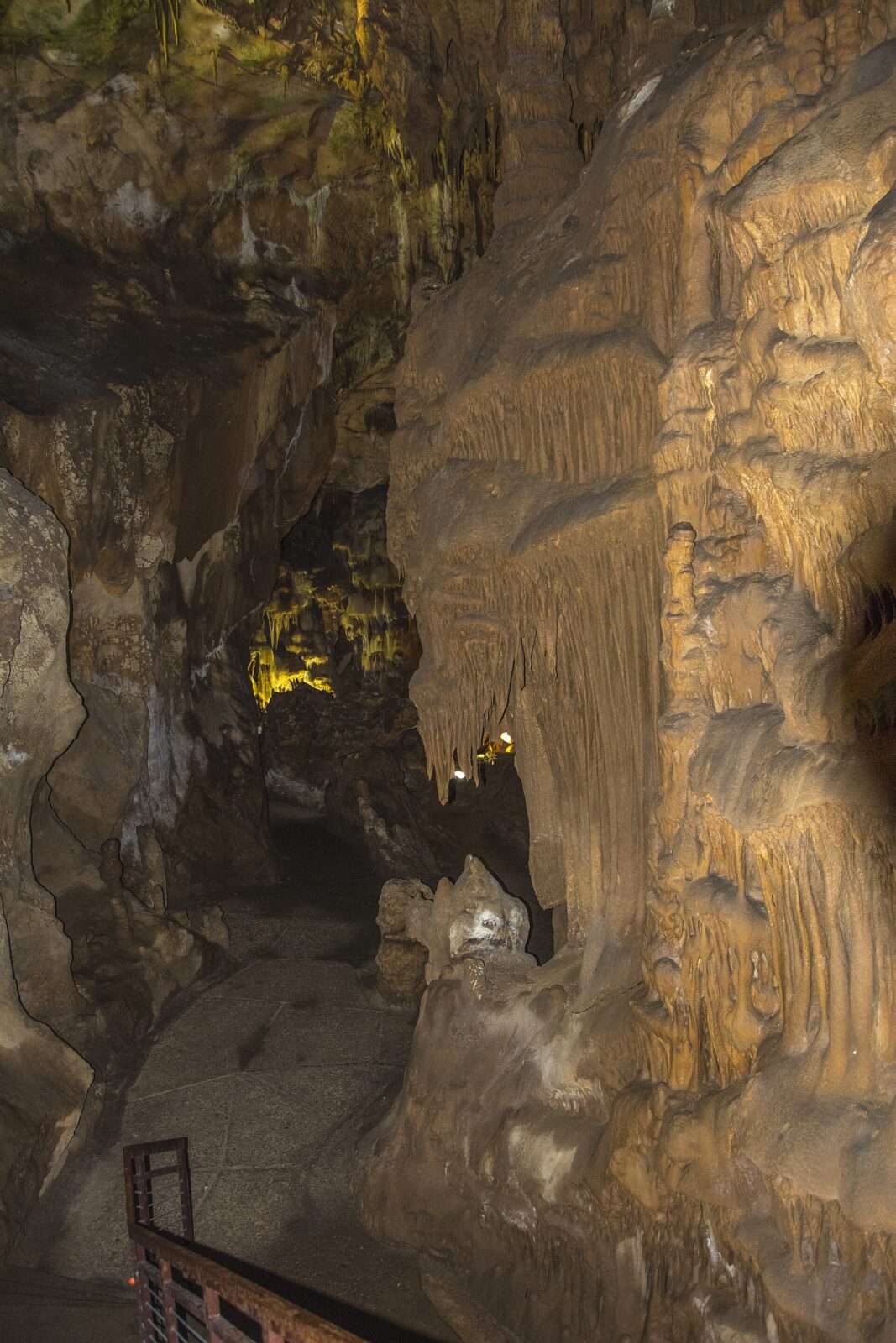 A large chamber along Resava Cave's lit route, with limestone formations above the walkway
