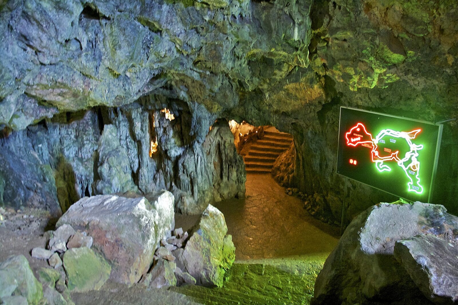 The lit entrance passage and steps at the start of Resava Cave's guided route