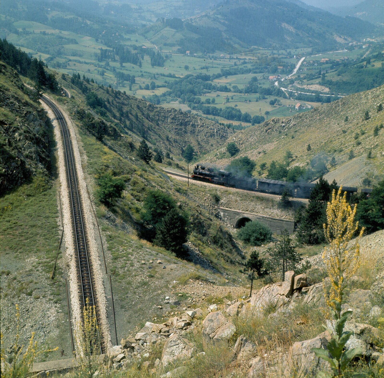 A bridge on the Sarganska osmica railway line climbing through the hills