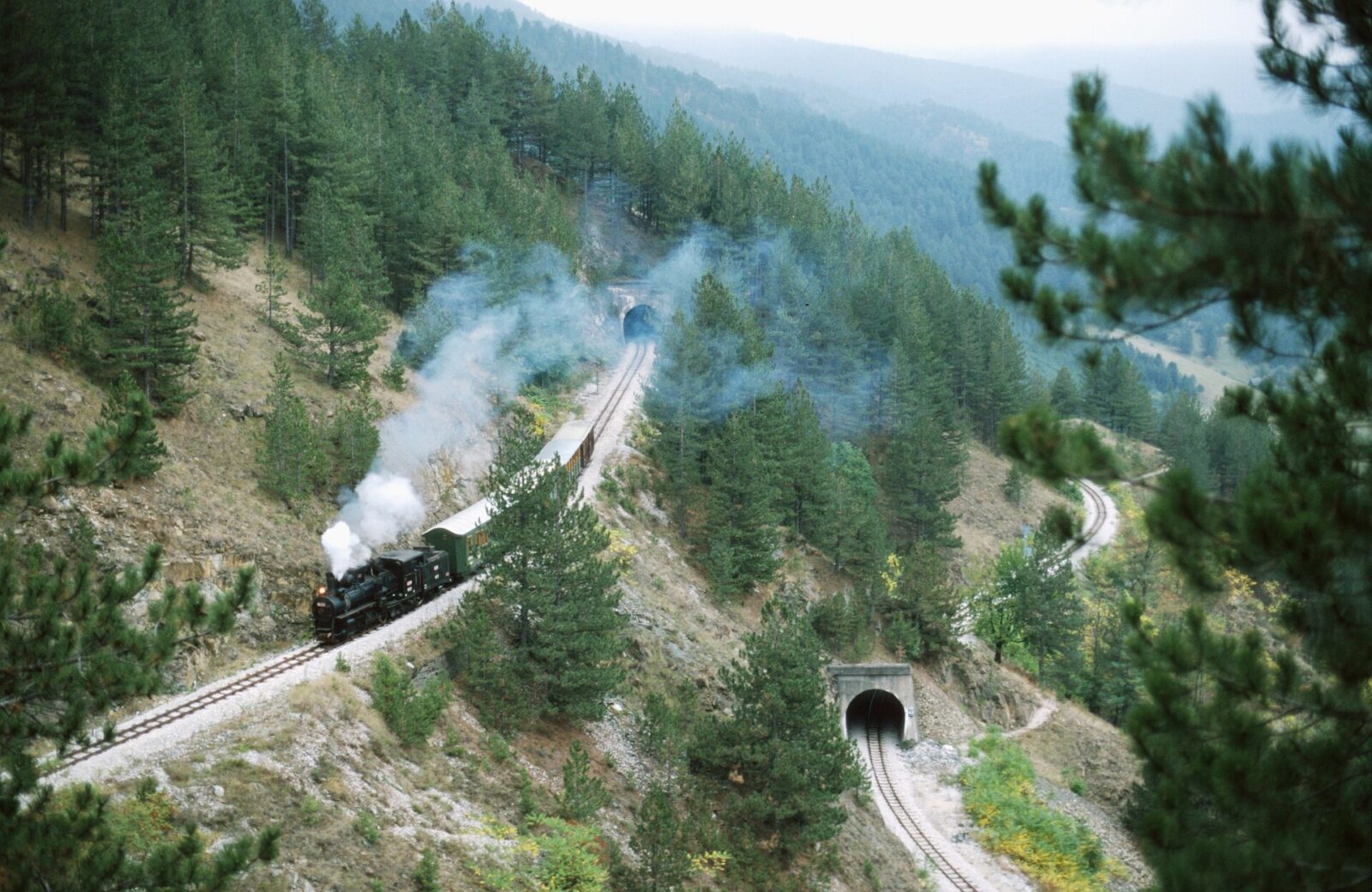 A train on the Šarganska osmica narrow-gauge line in the hills near Mokra Gora