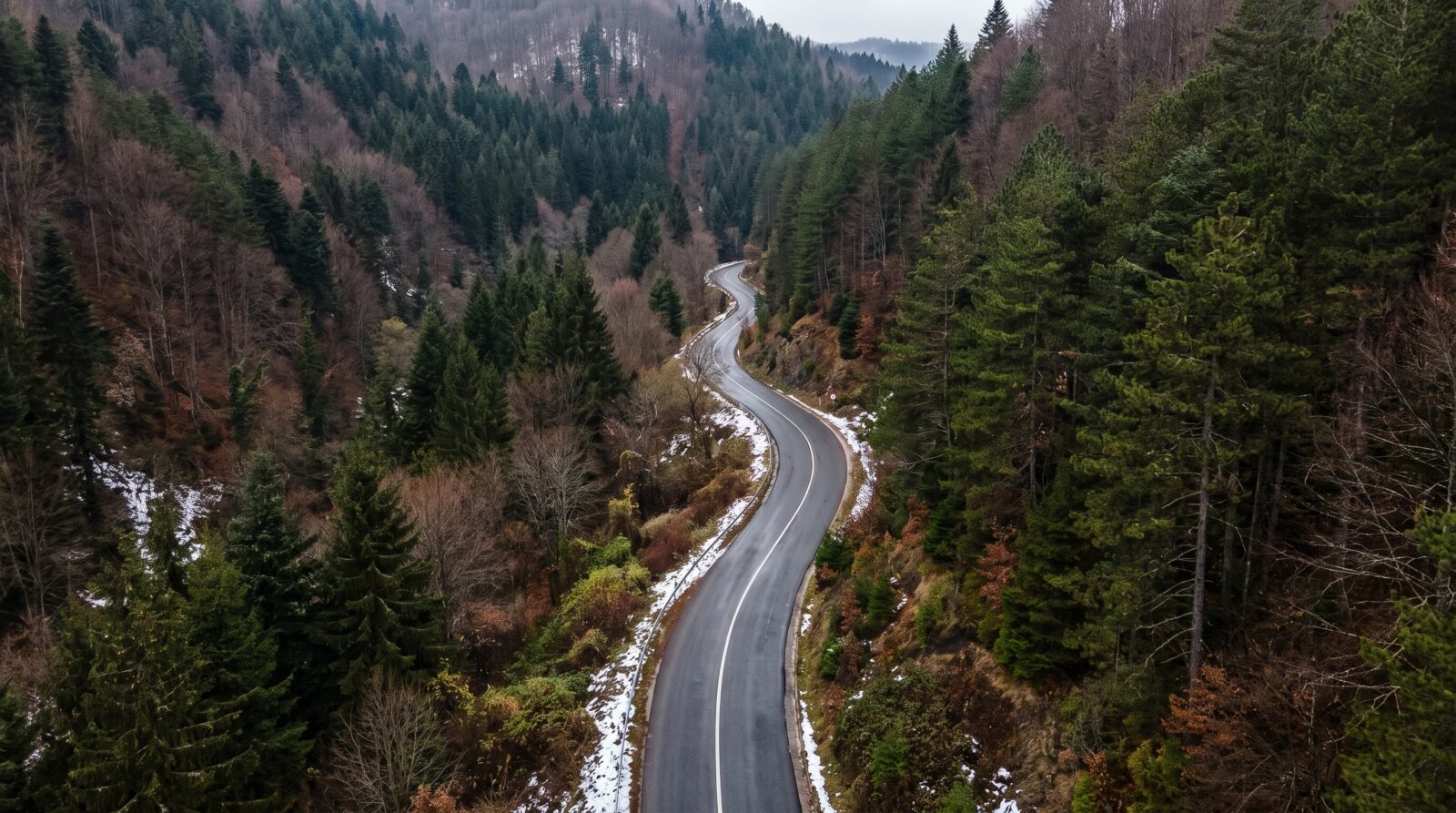 A mountain pass road curves through forested slopes in Serbia