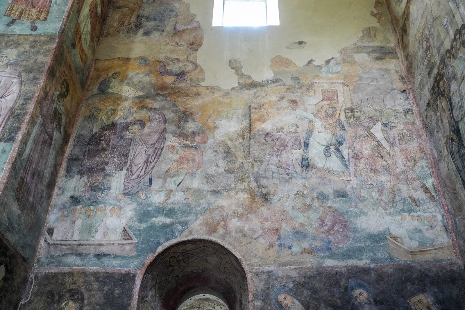 Weathered thirteenth-century frescoes on the nave walls of Sopocani monastery