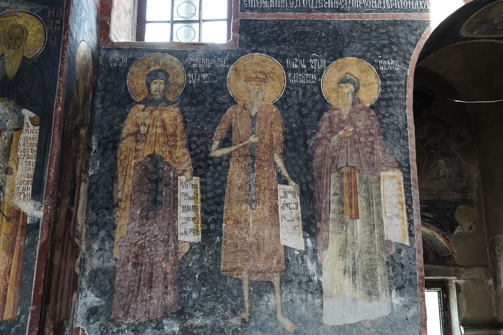 Byzantine-style frescoes lit by a narrow window inside the Church of the Virgin at Studenica