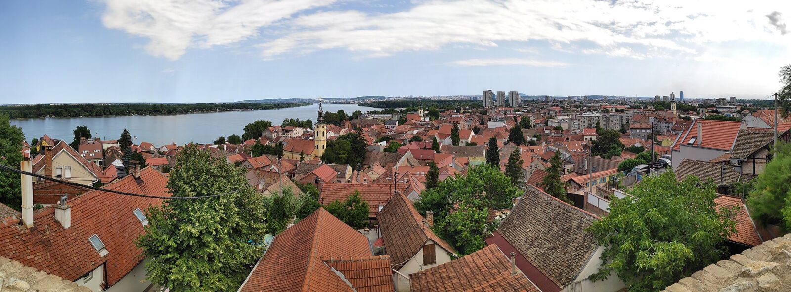 An elevated view over Zemun's old town rooftops toward the Danube, seen from Gardos hill